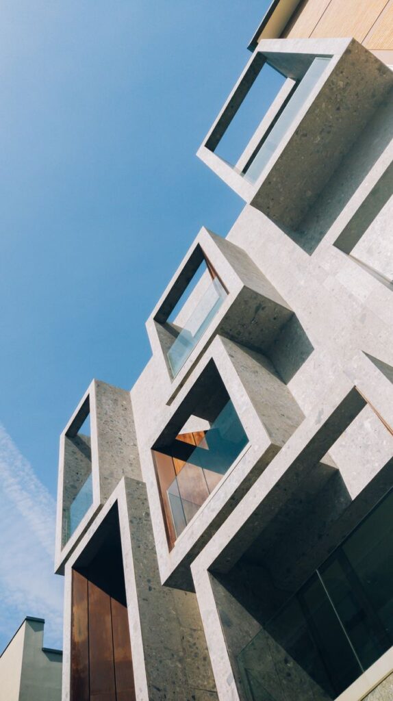 The Art of Drawing Readers In: Your attractive post title goes here Modern building with geometric design set against a clear blue sky, showcasing contemporary architecture.
